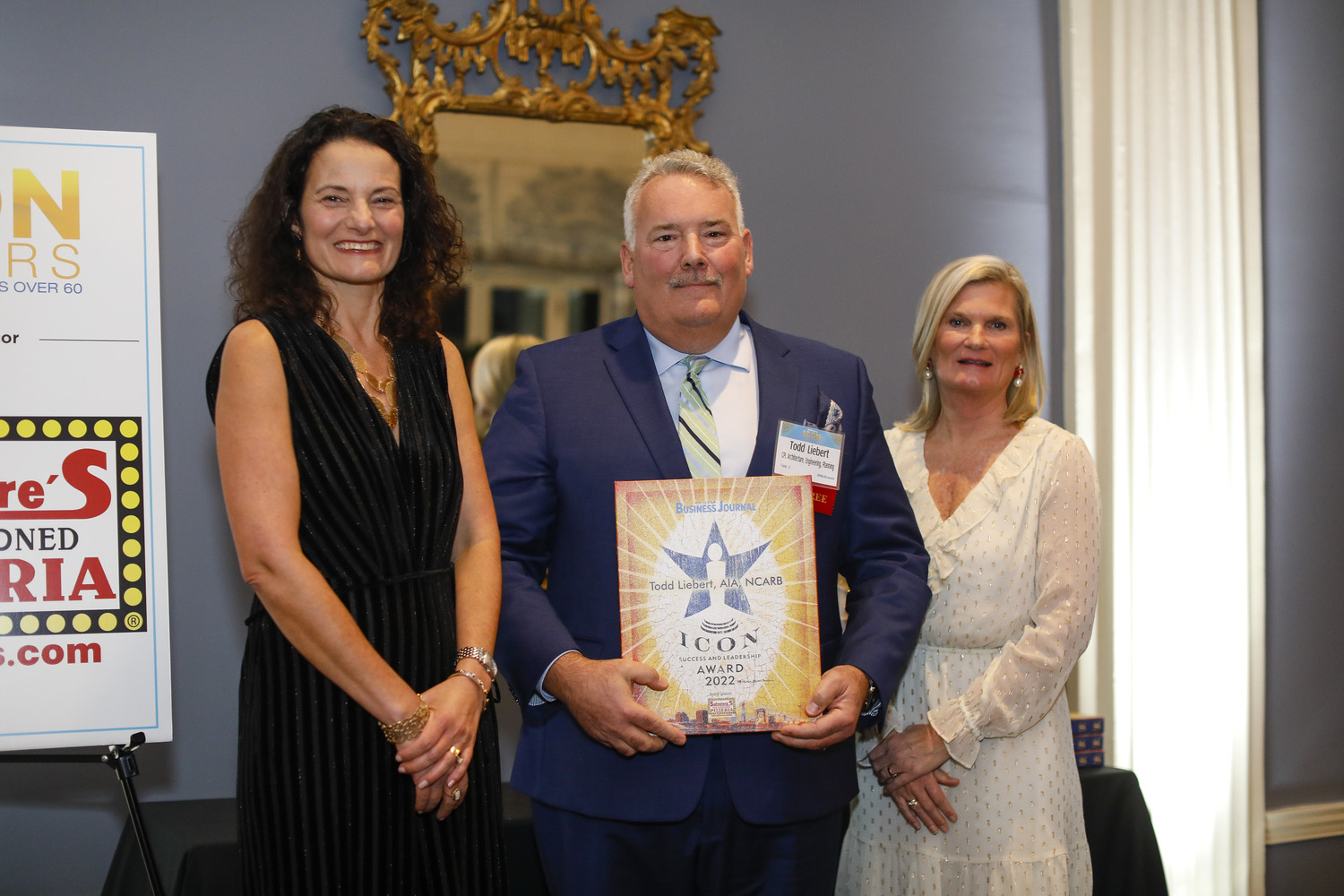 Image shows a woman, a man, and another woman standing next to each other and smiling. The man in the middle, Todd Liebert, CEO of CPL, is holding a 2022 ICON Honoree Award from the Rochester Business Journal (RBJ).