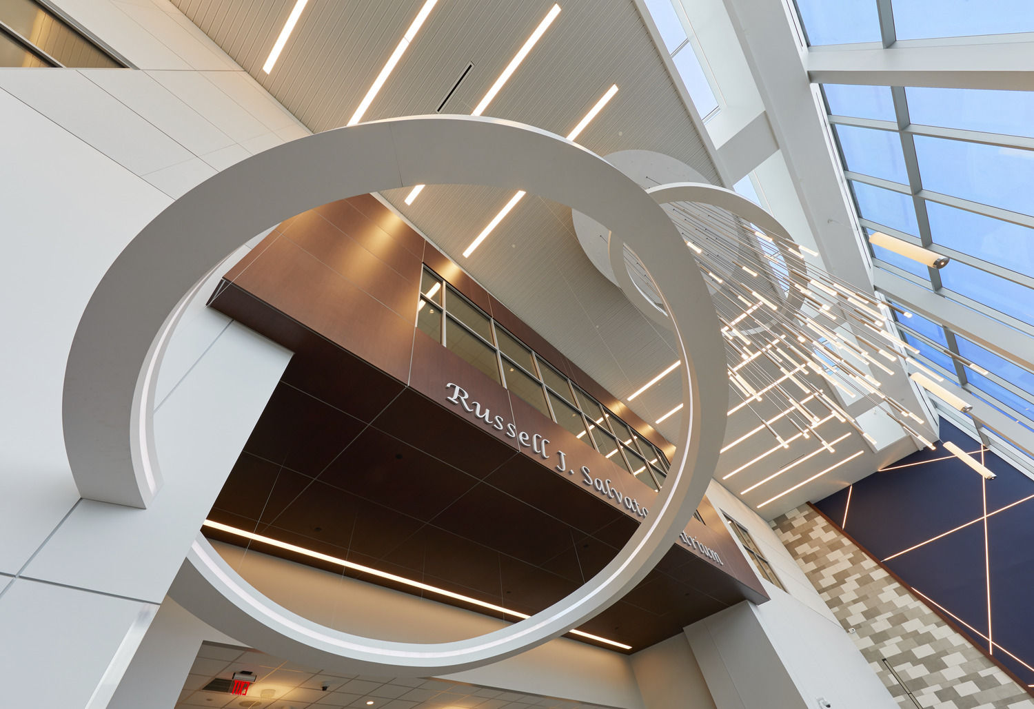 Modern, open and welcoming atrium highlighting lighting and ceiling details at Erie County Medical Center