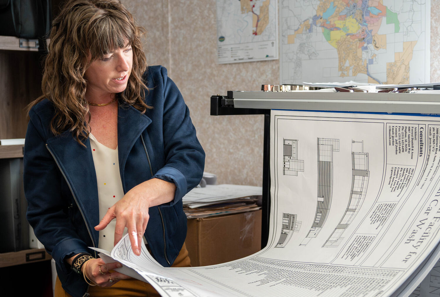 a woman looking at a large map related to Social Circle's Unified Development Code