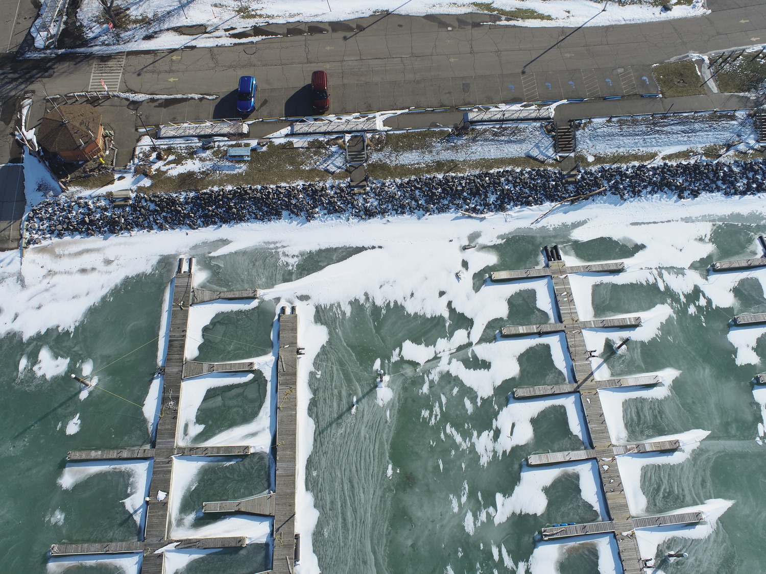 An aerial view of the docks in the frozen water at Sturgeon Point Marina