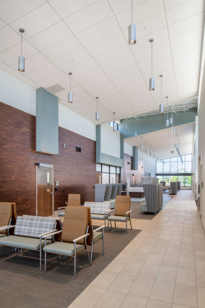 Veteran Affairs Community Outreach Clinic waiting room with various chairs and cylindrical light fixtures