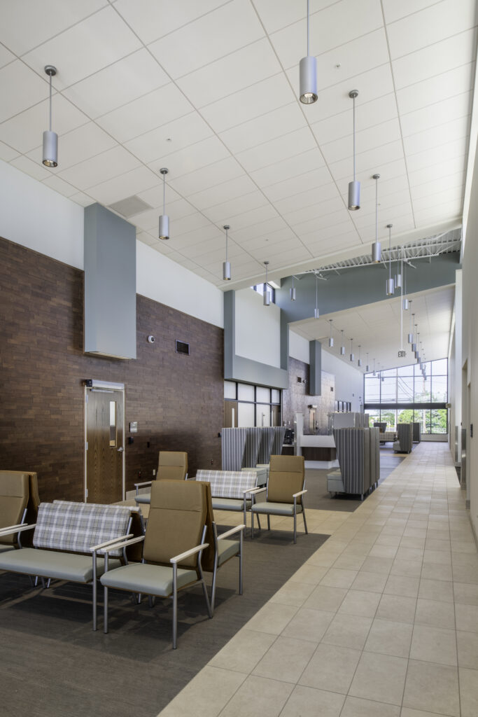 MPA_2021_001_N11 copy Veteran Affairs Community Outreach Clinic waiting room with various chairs and cylindrical light fixtures