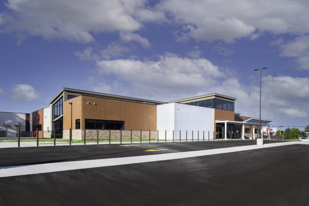 MPA_2021_001_N6 copy Veteran Affairs Community Outreach Clinic exterior with brick building and driveway/parking lot