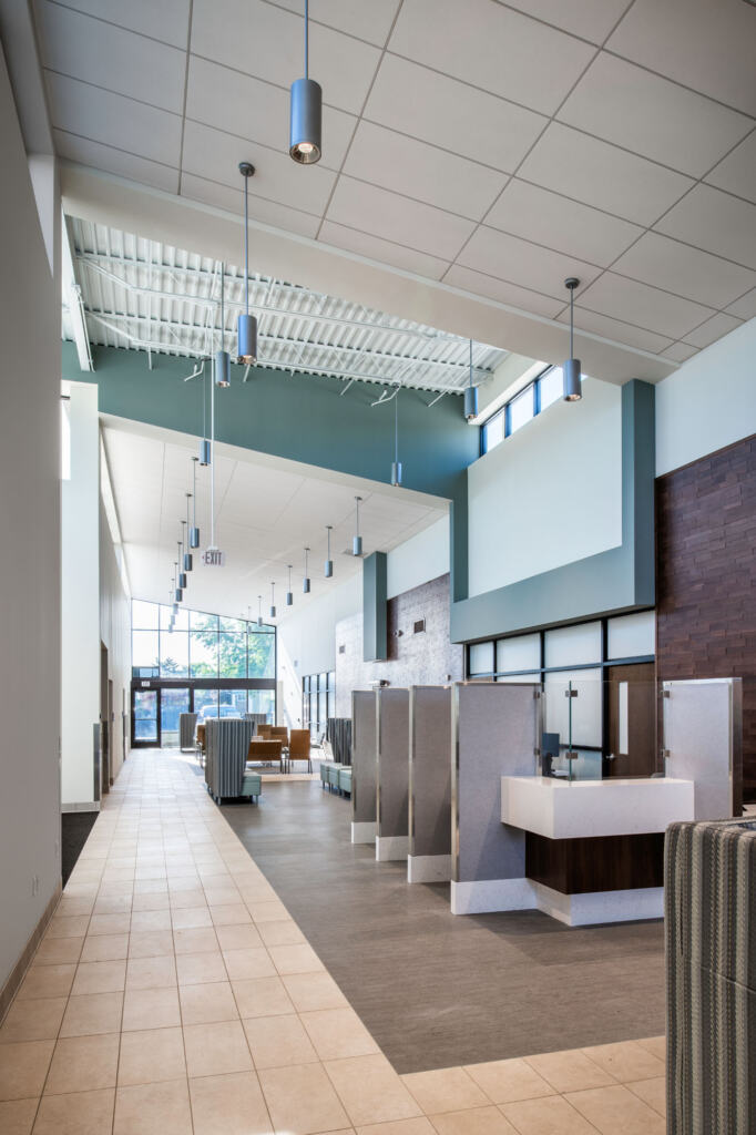 Veteran Affairs Community Outreach Clinic lobby/waiting area with tall booths, brick walls, and tile floors