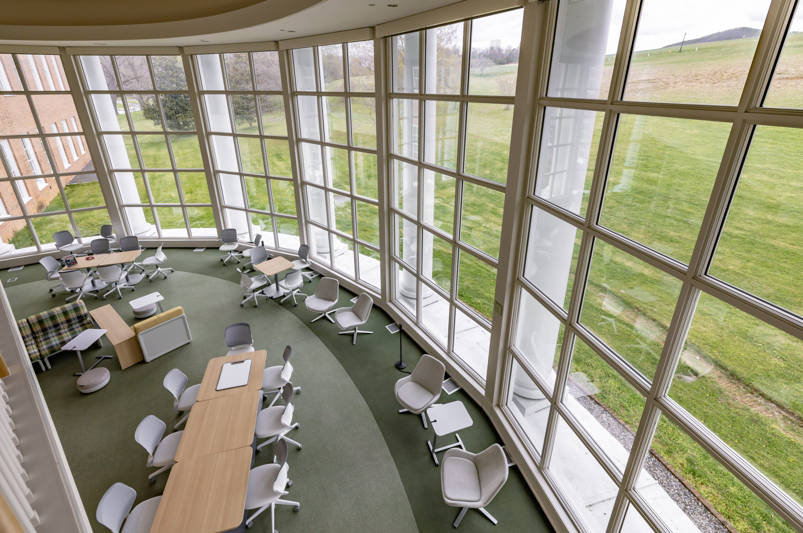 Hollins University Library reading room with windows and tables/chairs