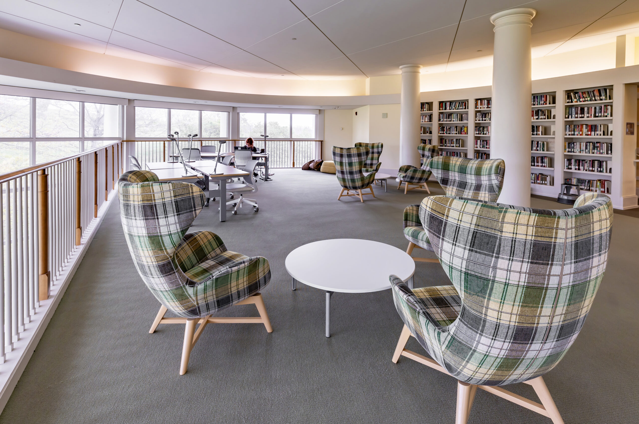 Hollins University Library reading room loft with bookshelves and plaid armchairs
