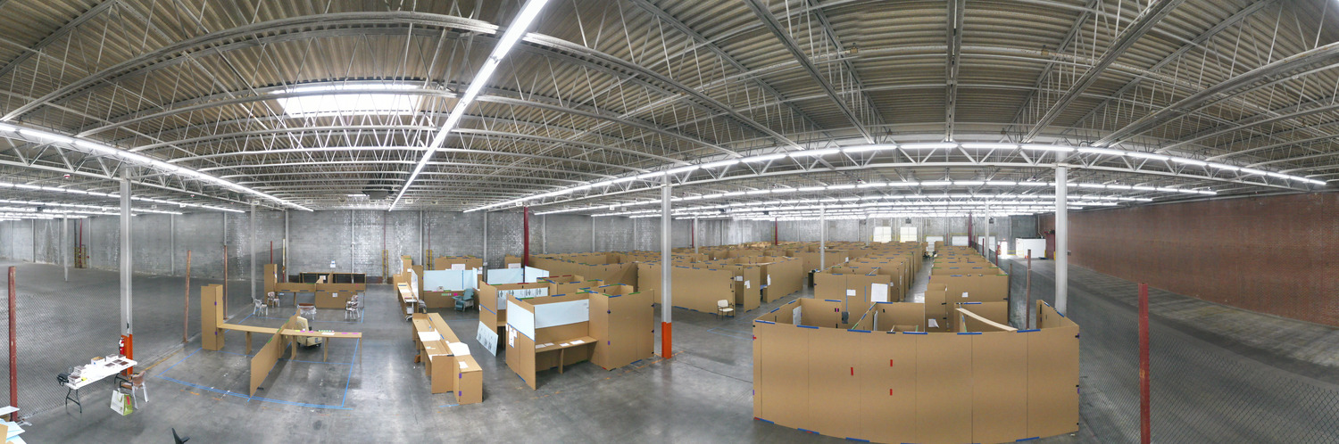 A cardboard mockup of clinical spaces within a warehouse.