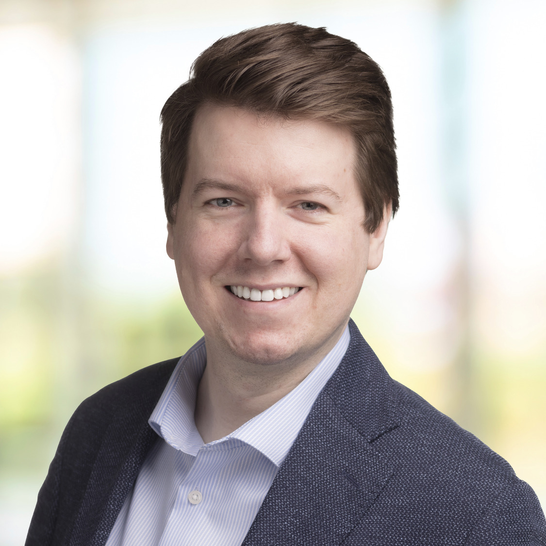 Headshot of Rob Ross smiling and wearing a suit.