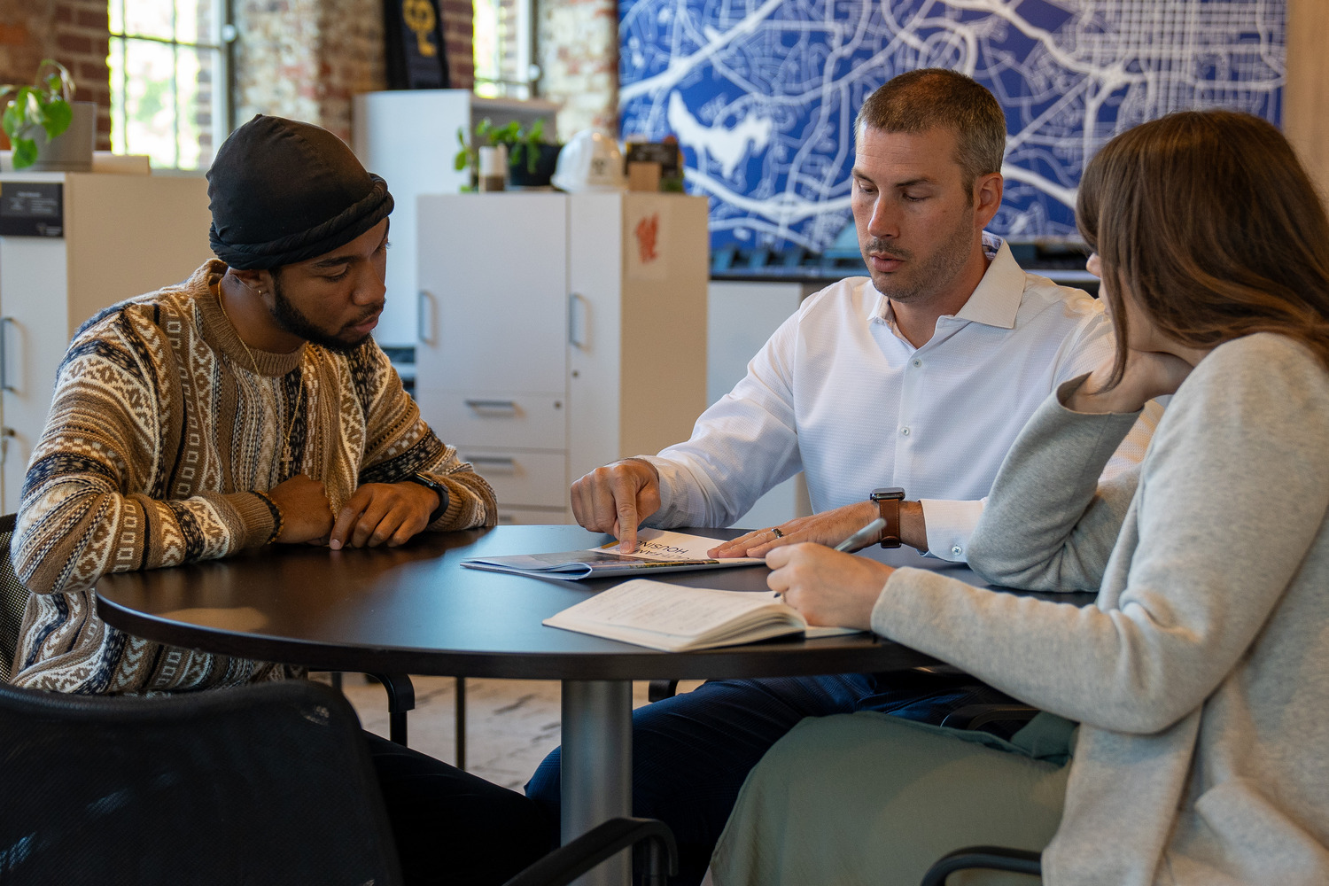 Graham Boyd mentors other architects at a table in the CPL Raleigh office.