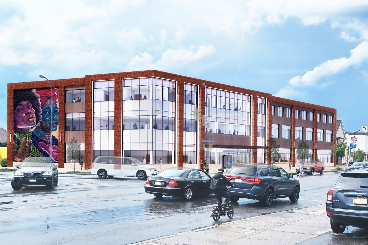 A rendering of the new Kensington-Bailey Health and Community center on Buffalo's East Side. The building is a brick facility with a colorful mural on the side, and traffic on the street in front.