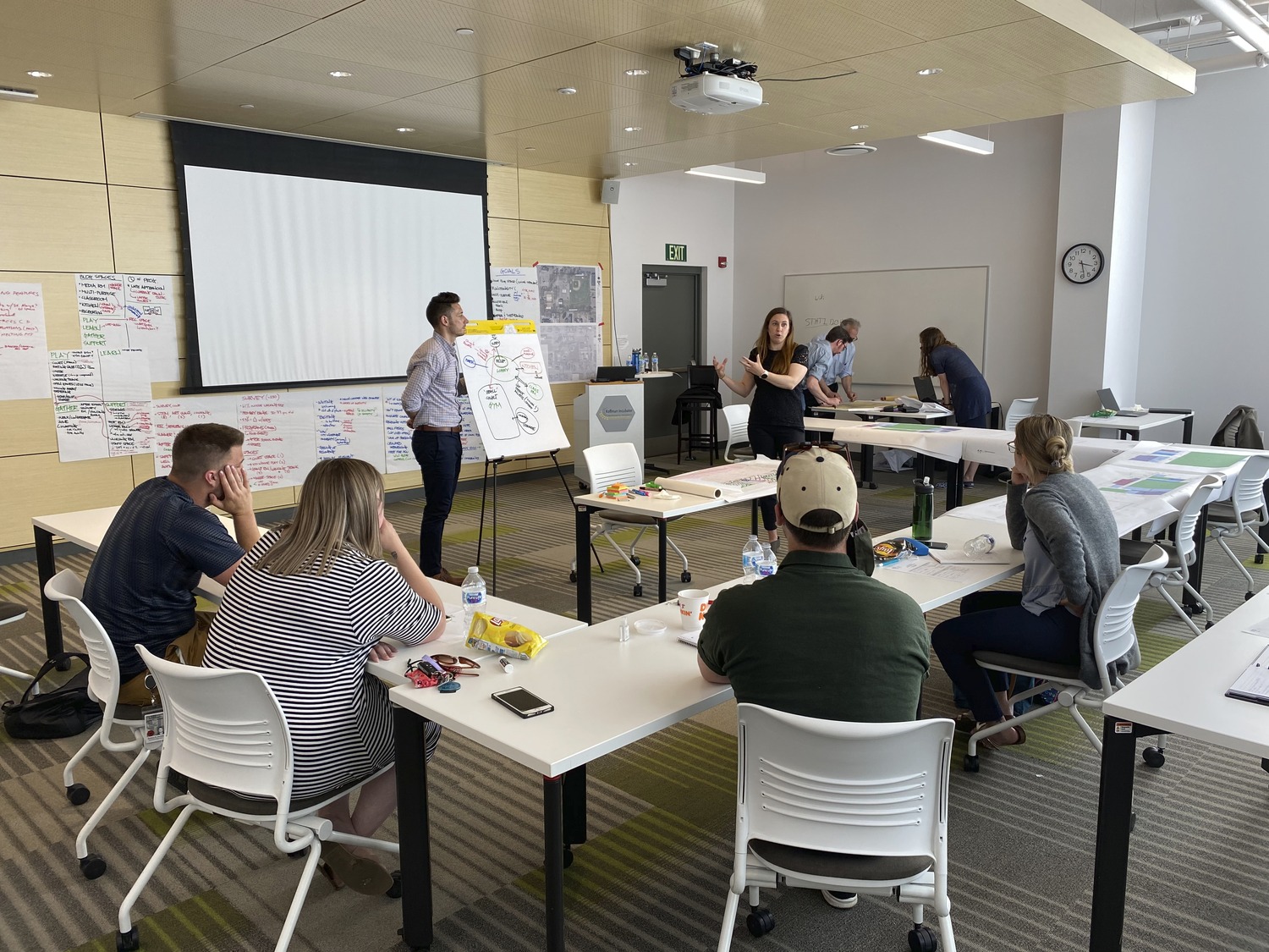 Group of architects, engineers, and designers brainstorm ideas together for Ossining theater's K-12 adaptive reuse project. Community engagement.