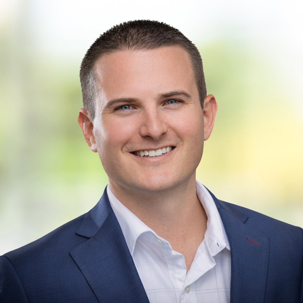 ELeibenguth_Headshot_Background Headshot of Eric Leibenguth, a man smiling in navy blue suit jacket