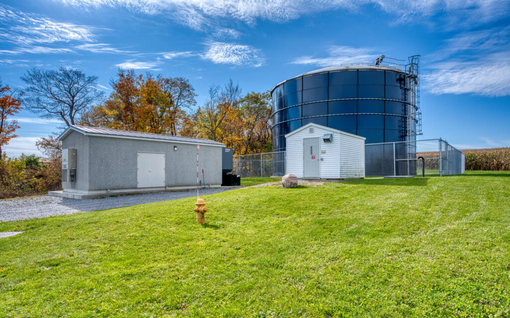 Ground view of York Water Tank with yellow fire hydrant on green grass