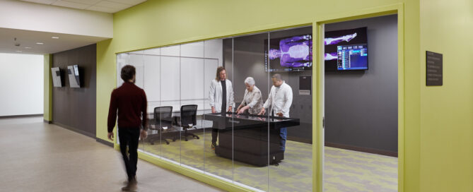 Medical students practicing with high-fidelity manikins in a hospital-like simulation room with medical equipment on Union Square Campus.