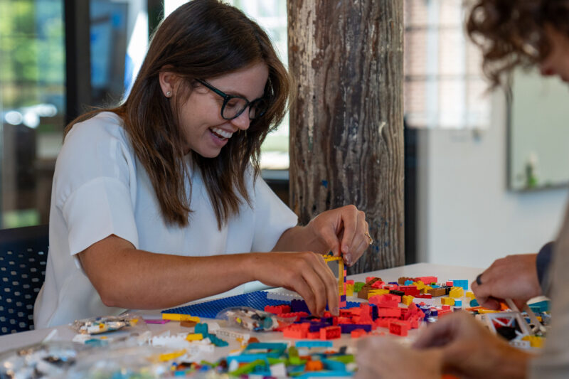 Woman playing with Legos having fun
