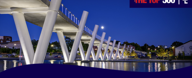 Graphic that shows a pedestrian bridge at Suwanee Town Center and DeLay Nature Park. In the corner is Engineering News Records (ENR) Top 500 logo and CPL's logo. At the bottom is a wave shape in CPL dark blue with white writing on top that reads "CPL has ranked on the ENR Top 500 Design Firms"