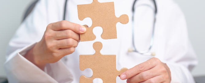 Healthcare professional connecting puzzle pieces to symbolize integrated autism care.