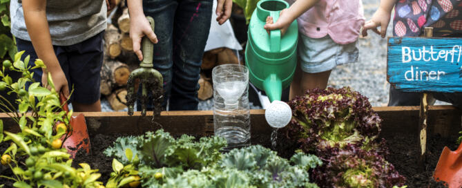 Kids Watering Plants in a small garden