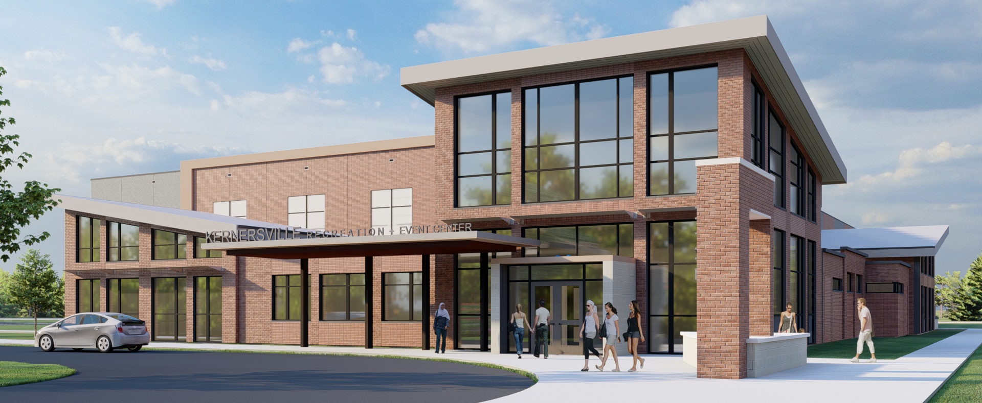 A rendering of the exterior of the rec center showing a traffic loop and groups of people walking in and out.