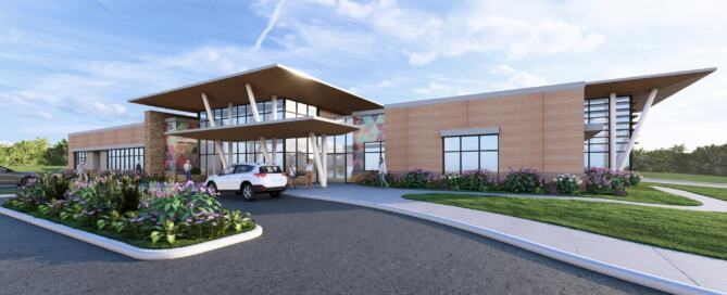 Orange County Behavioral Health Diversion Center with modern wood-paneled exterior, large windows, landscaped entrance, and covered drop-off area.