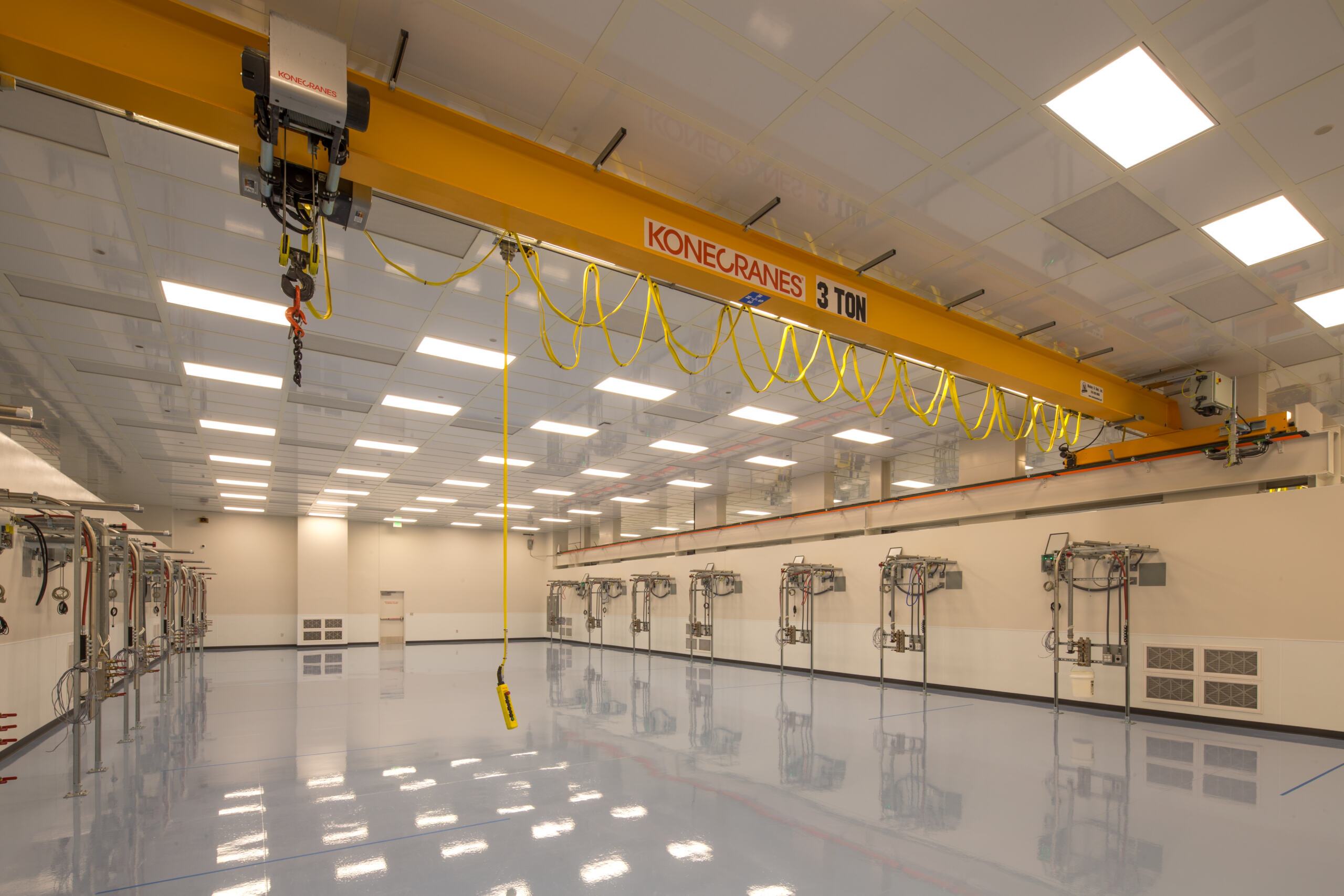 Clean room with yellow metal beam and blue reflective floors