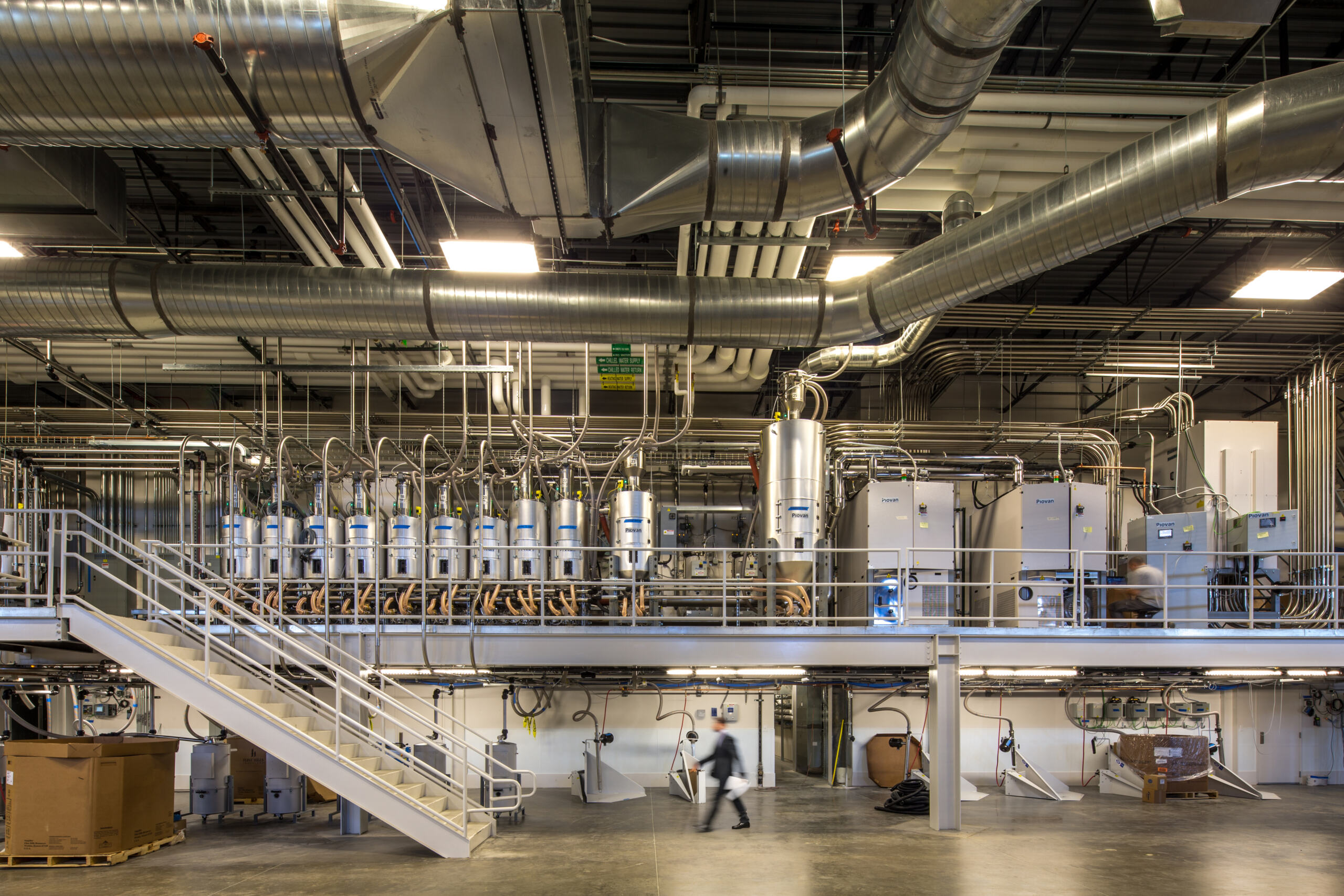 Industrial setting with many pipes and ducts at Nordson Value Plastics