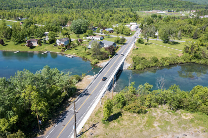 Cars pass over the Alexandria Avenue bridge, which transitions seamlessly into the rest of the avenue.