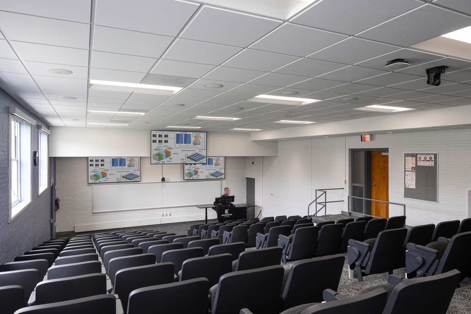 A professor delivers a presentation at the front of a Bowman Hall lecture hall.