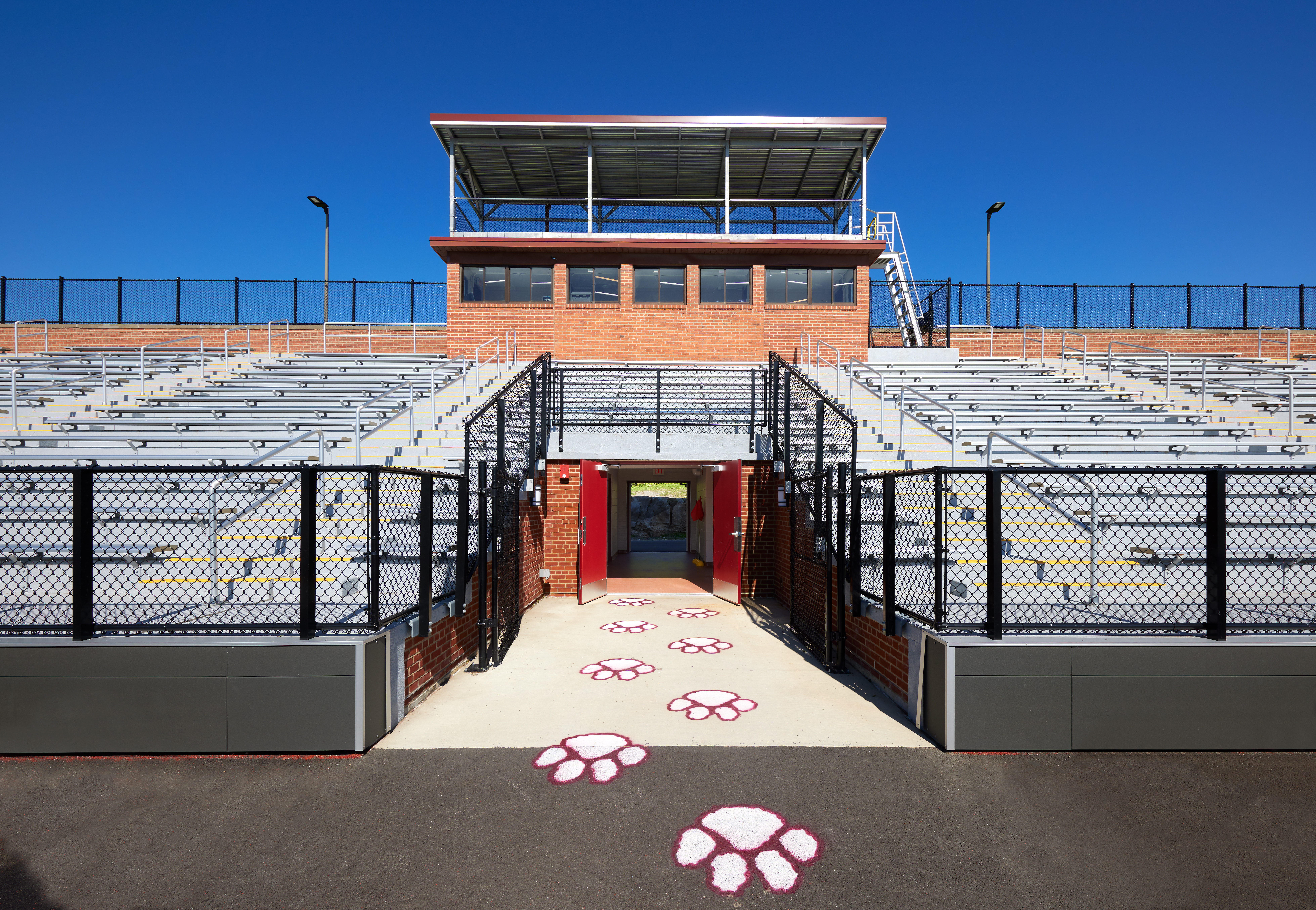 Deitz Stadium Dietz Stadium seating and press box from below, and a red and white paw print design leading out of the entry tunnel onto the field.