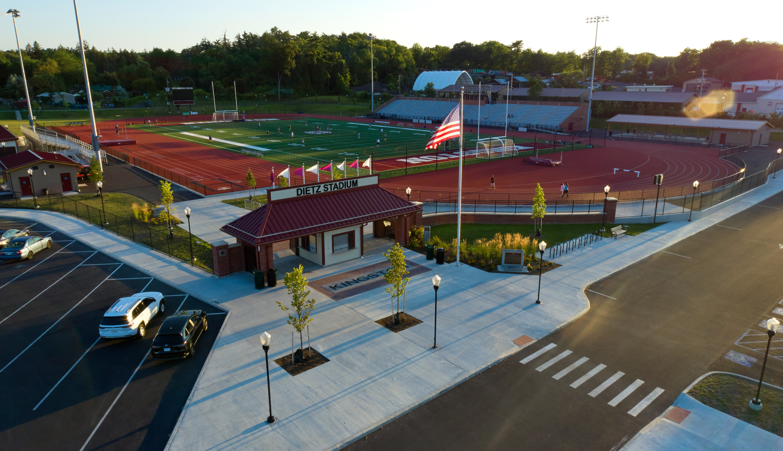 Deitz Stadium A bus loop and bus parking spots, a small concrete plaza, landscaping, and a ticketing booth with a sign reading Dietz Stadium.