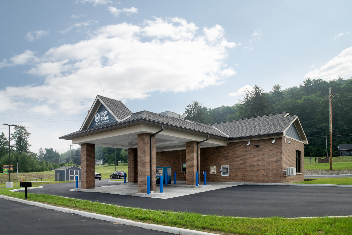 A covered drive-thru structure with brick pillars at the back of the High Point Federal credit union.