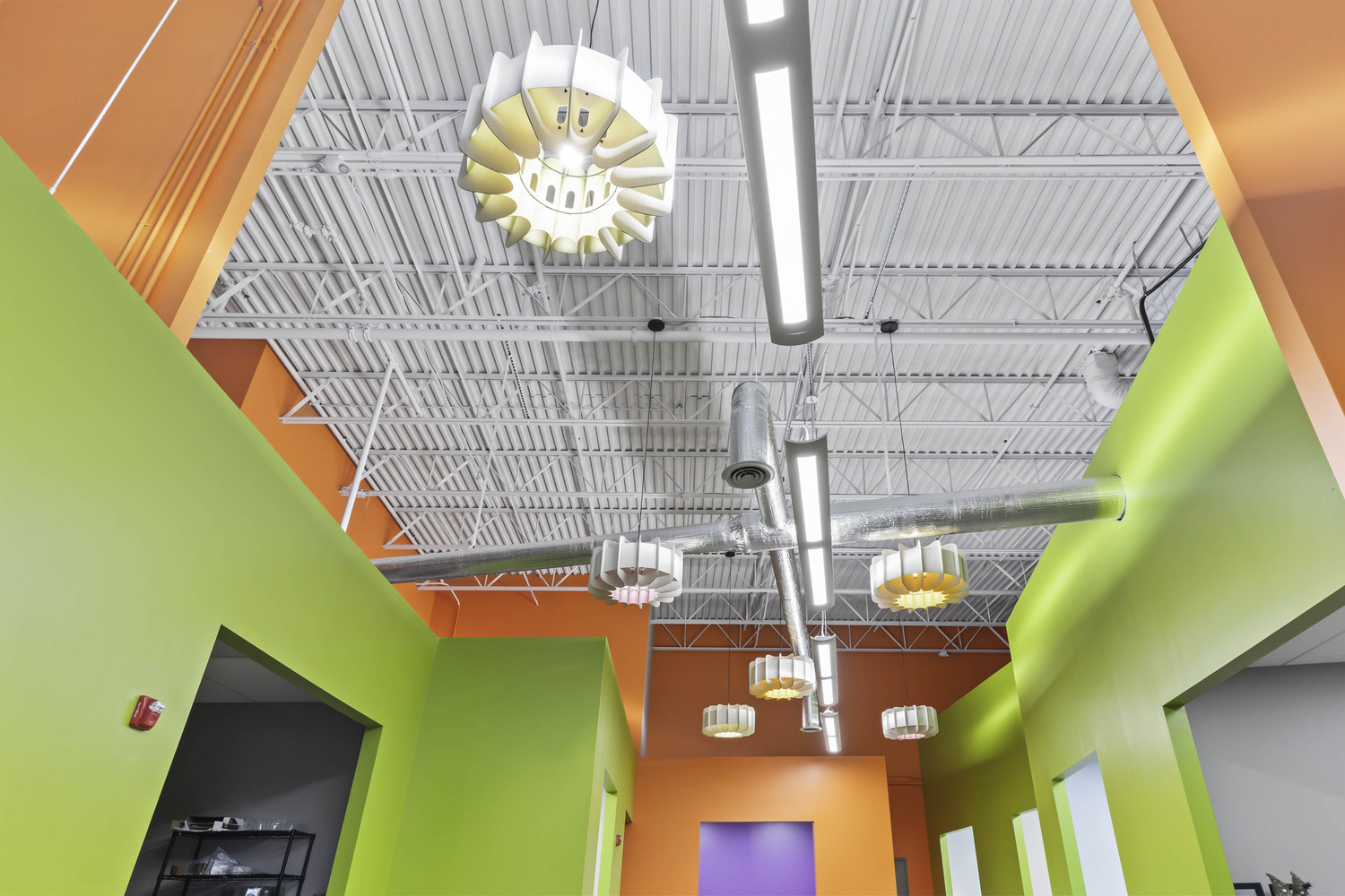 The tall, industrial ceiling of Solut! Offices and Manufacturing Facility.