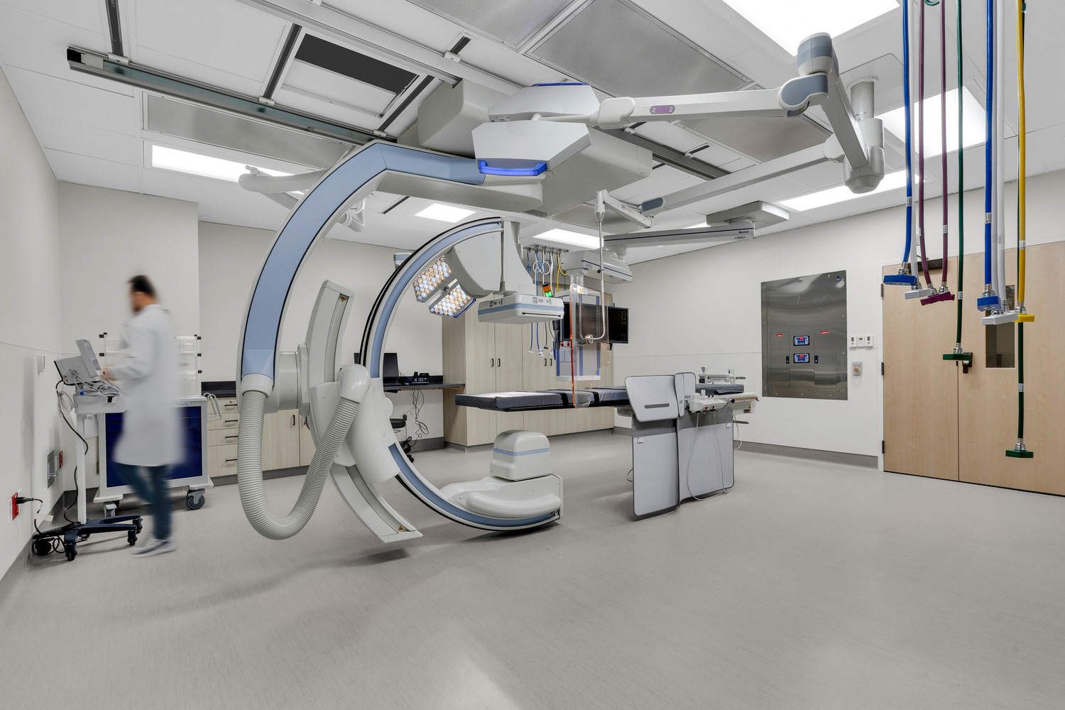 A surgical suite in Trillium Surgery ASC, including a ceiling-mounted C-arm and various other medical equipment.