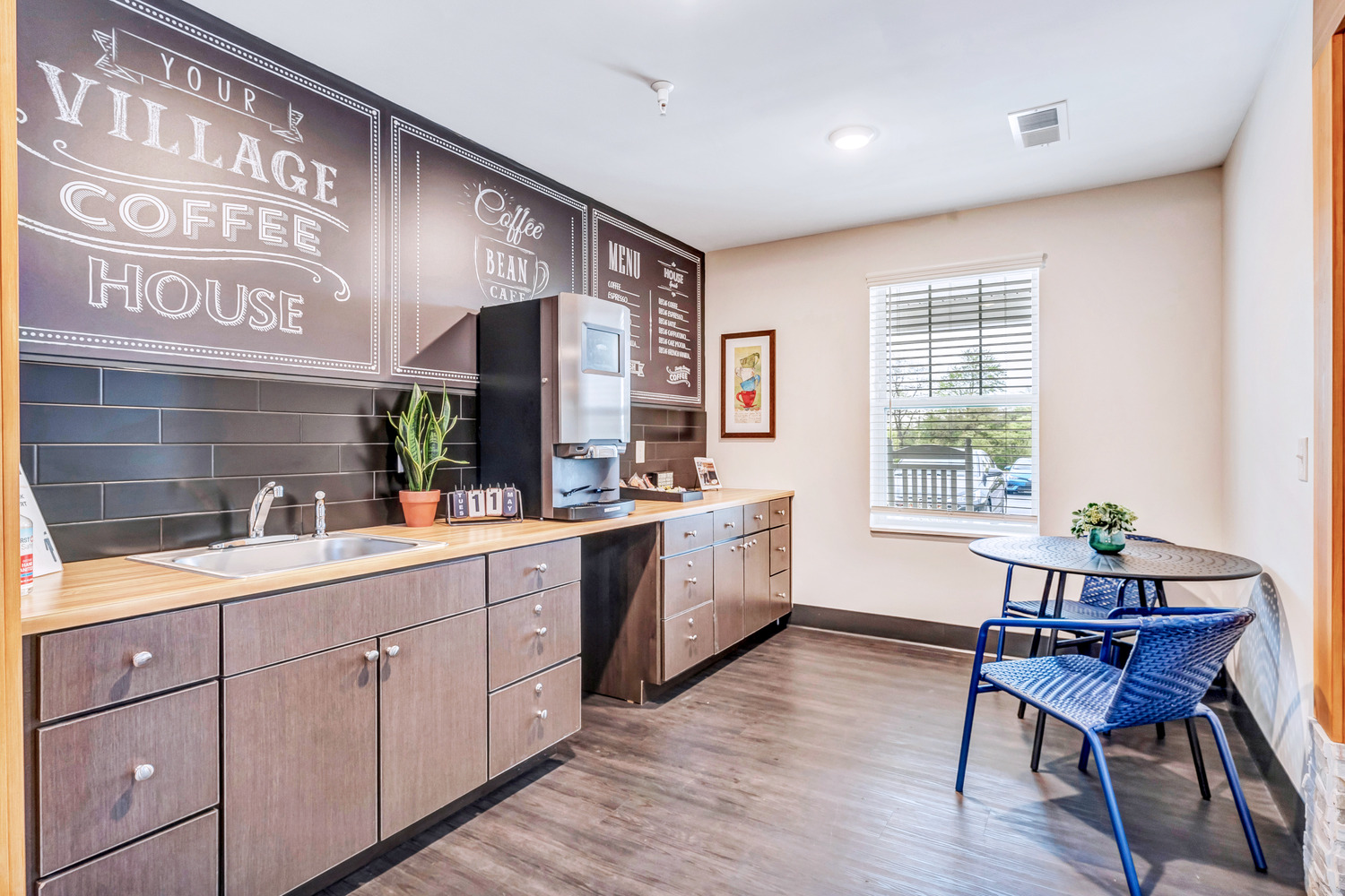 Homestead Village Active Senior Living Facility's coffee bar, with blackboard-and-chalk-style signage and menu above a counter.