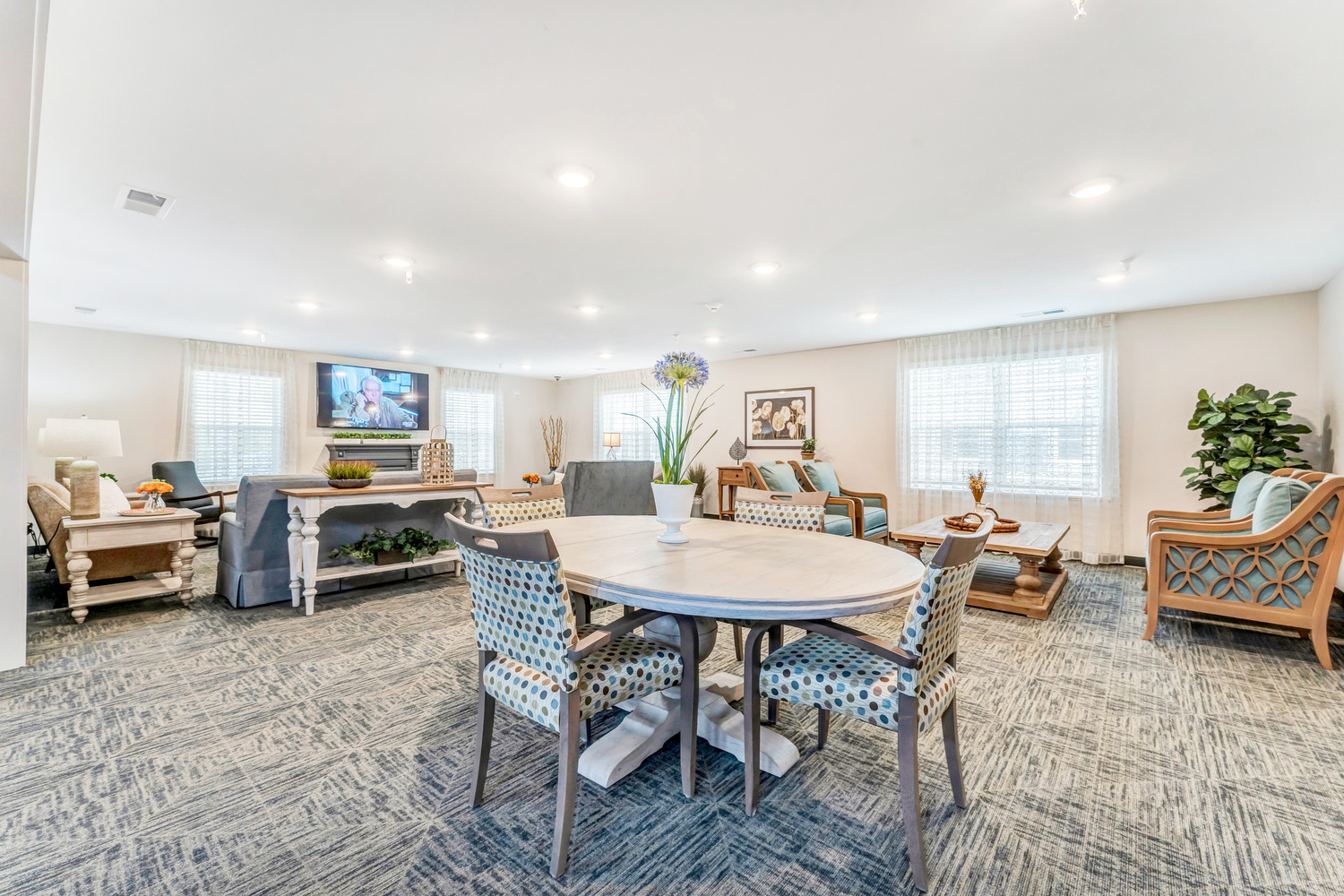 A common area in Homestead Village Active Senior Living Facility with various sets of furniture.