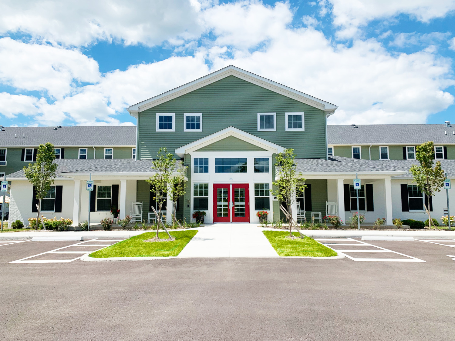Homestead Village Active Senior Living Facility's exterior and entrance to residential units.