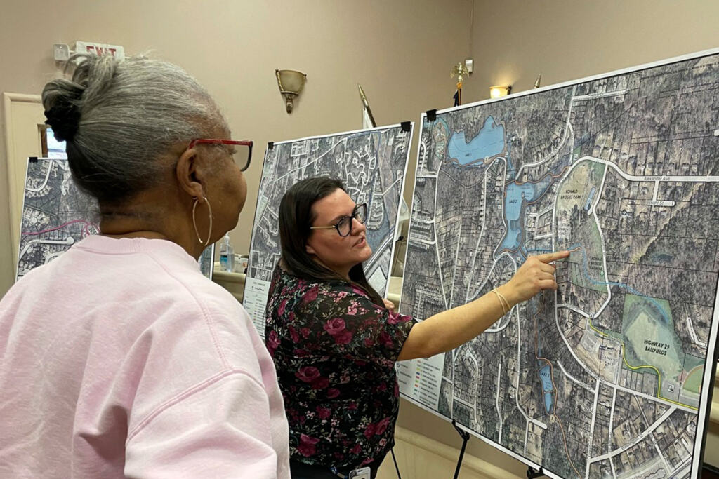 A CPL team member points at a map showing the Union City Trails Master Plan to a citizen of Union City