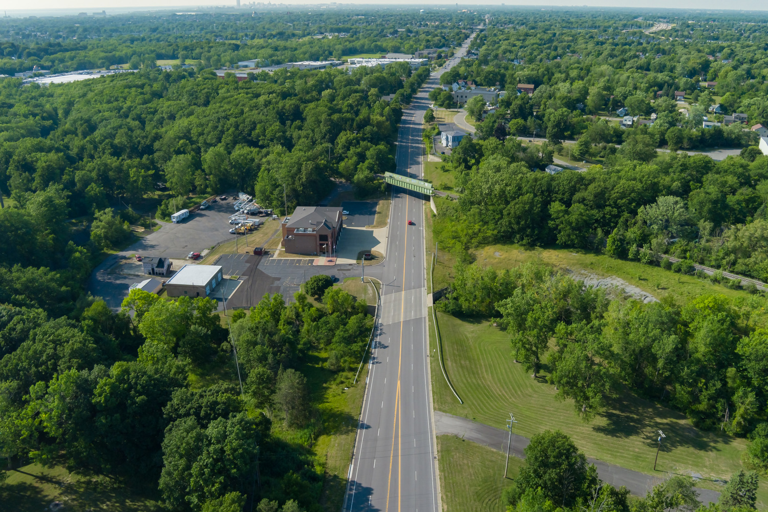 Erie County Dept of Public Works – Abbott Rd & Willett Rd Rehab An aerial view showing one of the smooth, freshly marked roads as part of the Abbott Road & Willett Road Rehabilitation and surrounding forests.