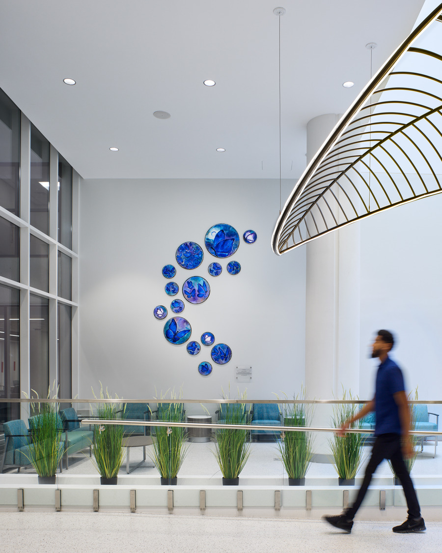 Atrium Health Wake Forest Baptist Outpatient Surgery, man walking in the foyer of the Julie Ann Freischlag Tower