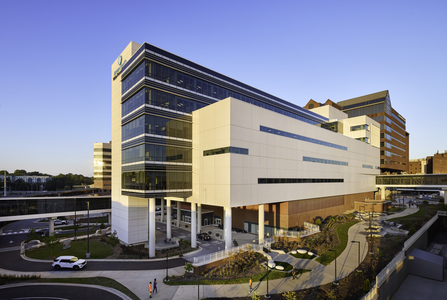 Drone view of exterior of the Atrium Health Wake Forest Baptist Medical Center Care Tower, evening light