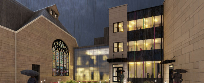Exterior of Ossining UFSD High School CTE Building, a former church, at night during rainfall.