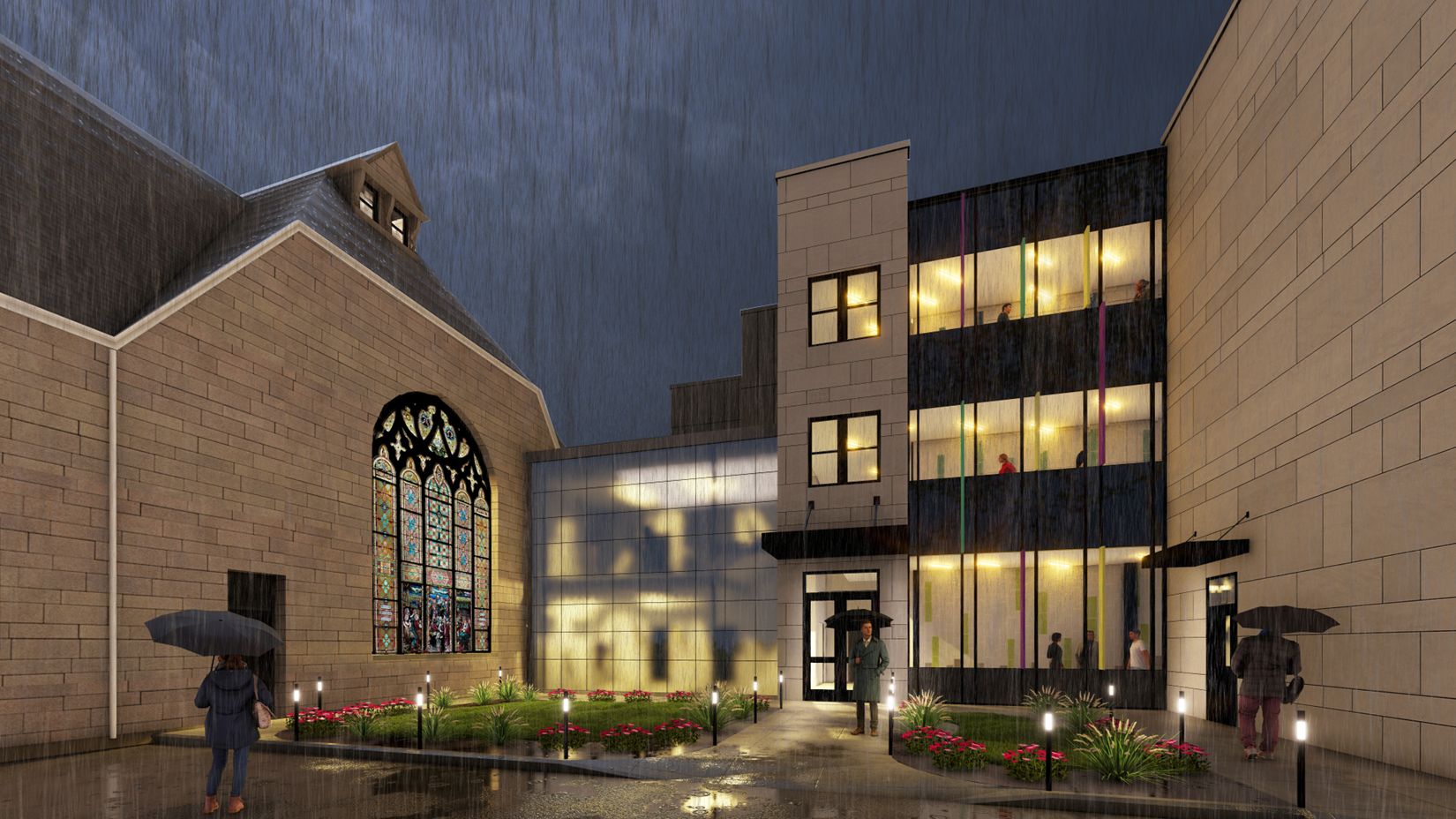 Exterior of Ossining UFSD High School CTE Building, a former church, at night during rainfall.