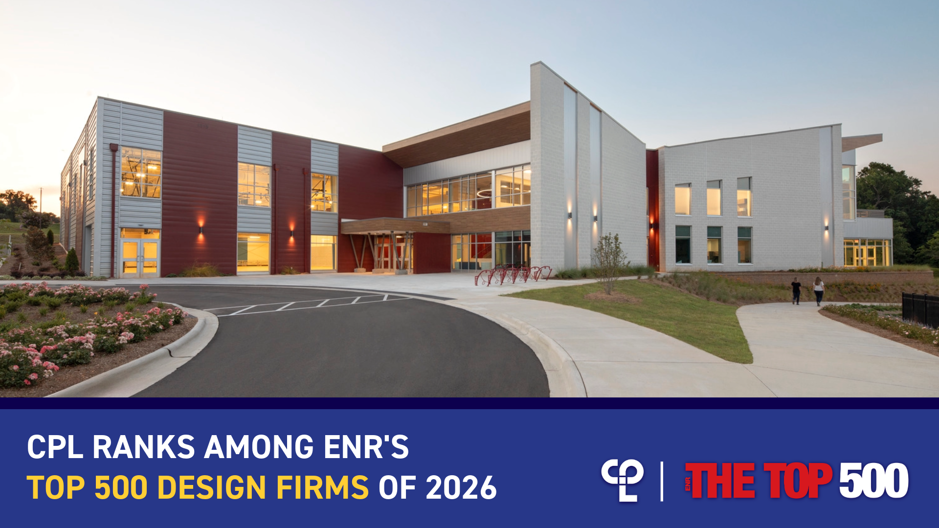 Exterior of a community center with vibrant red accents, and a blue banner announcing CPL's ENR Top 500 Design Firms placement.