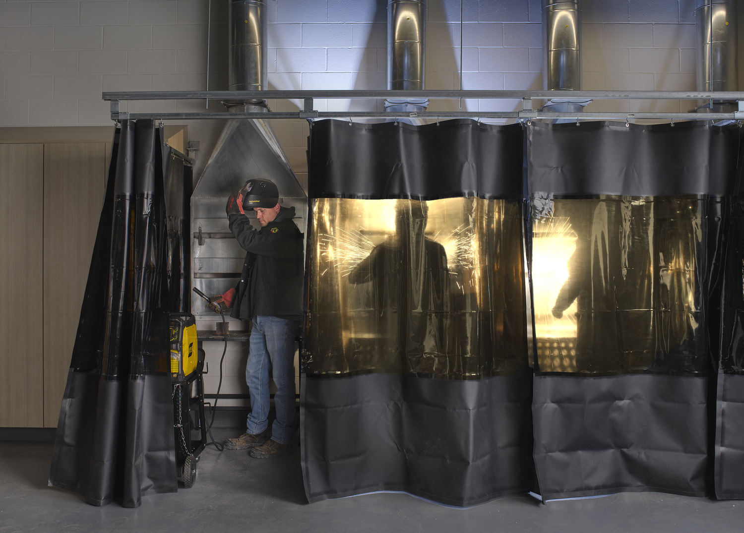 Curtains part to show students using a welding and construction space at Fillmore CSD, part of their 2023 Capital Improvement Plan.