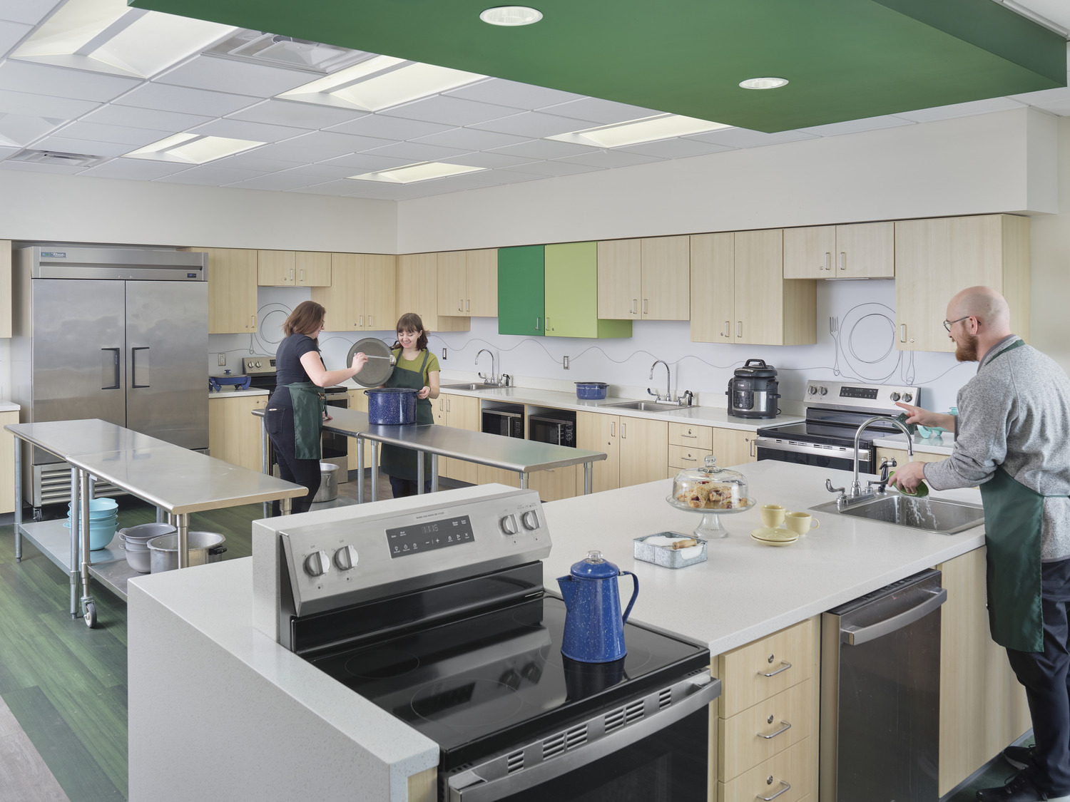 Fillmore's Capital Improvement Plan introduces a Family and Consumer Sciences classroom with kitchen appliances and long, stainless steel tables, where students check on a recipe in a large pot.