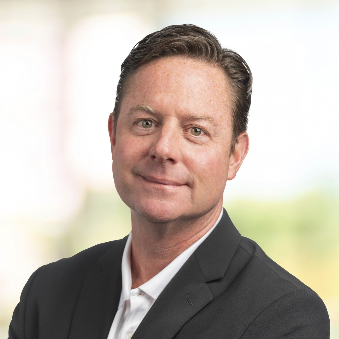 Bill Greeley headshot showing a man in a white shirt, black blazer, smiling.