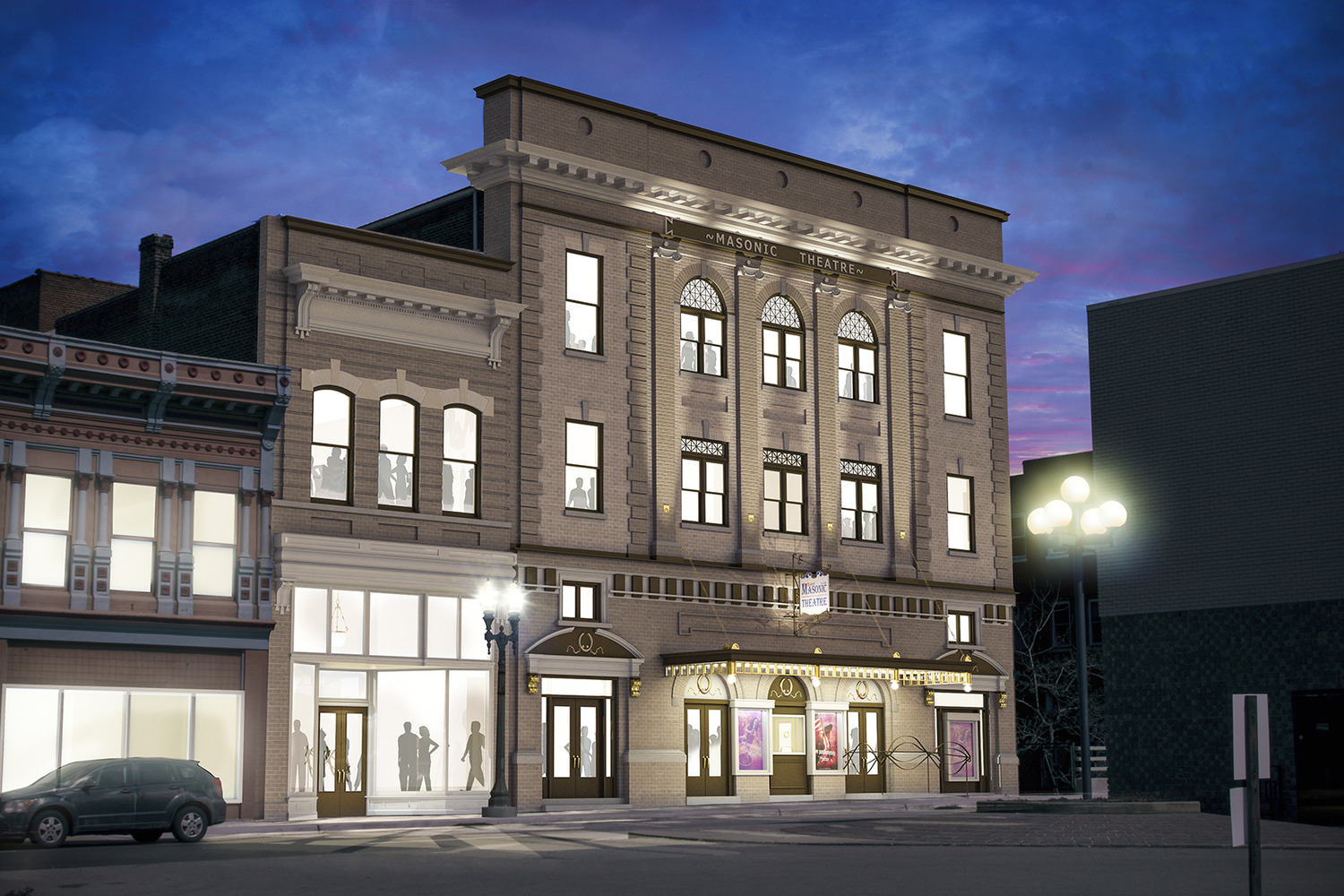 Historic theater building in evening light, showcasing illuminated windows and classic architecture. Street lamps cast warm glow; sky is dusky purple-blue.
