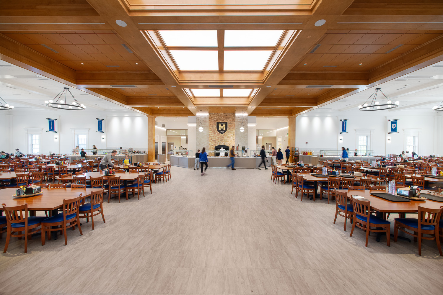 Mercersburg Academy campus dining hall renovation showcasing a renovated dining space with wood furnishings, natural light, and a welcoming atmosphere.
