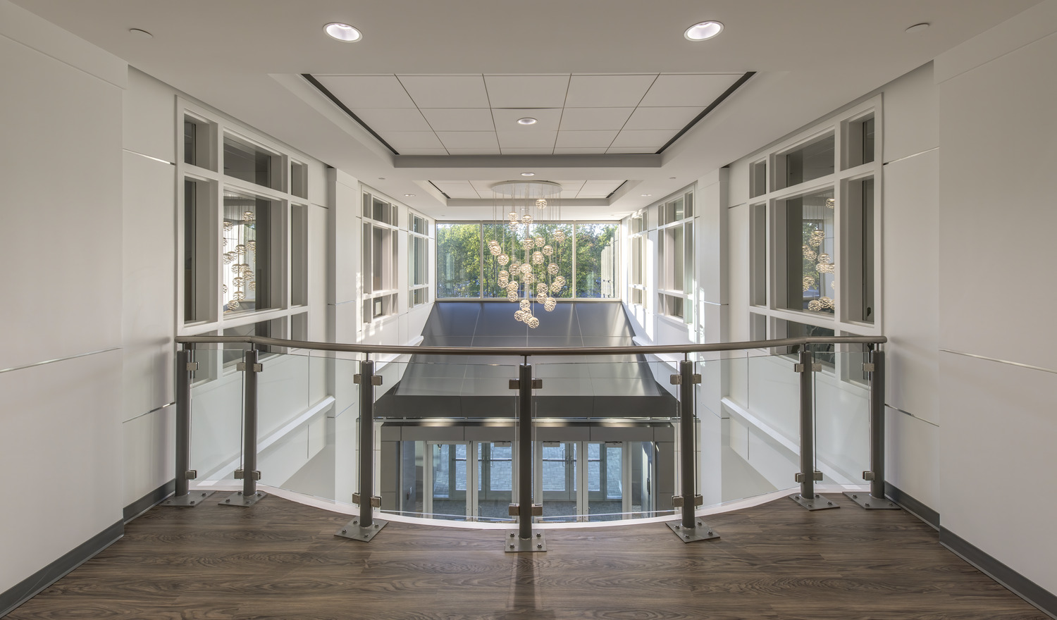 Open second floor clear-story overlooking entrance area with decorative light fixture and glass panels at the Johns Creek Municipal Center